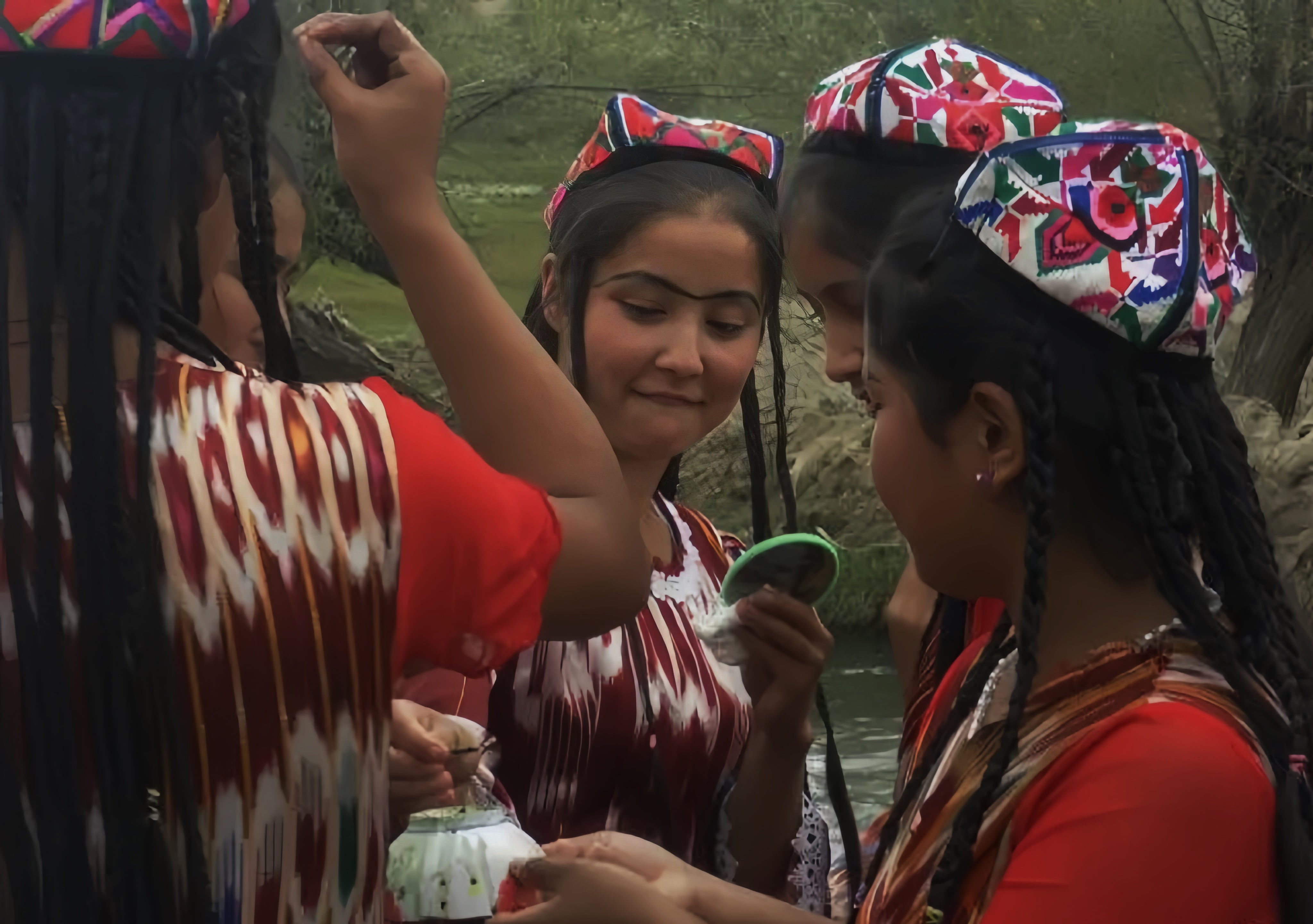 some Uyghur girls applying Usma grass on their eyebrows.